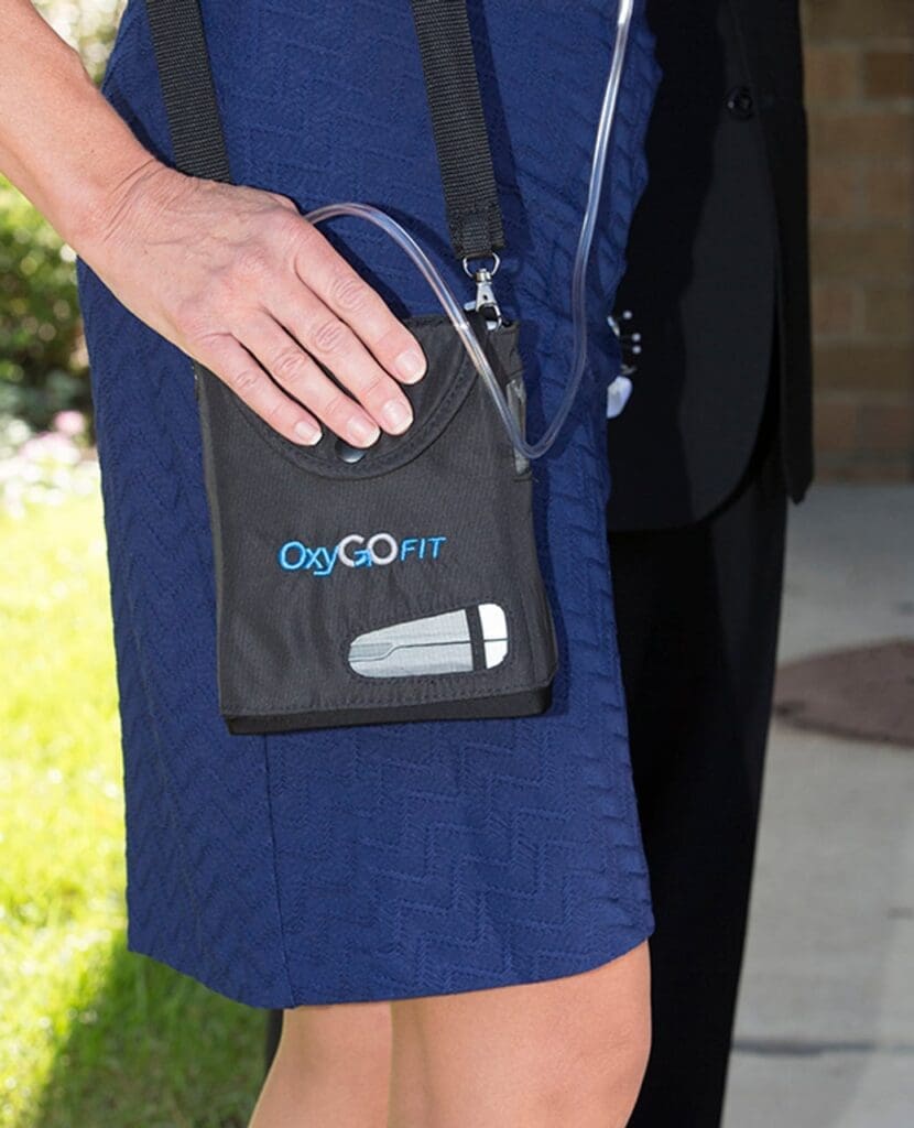 Oxygo Fit portable oxygen system carries on lady's shoulder